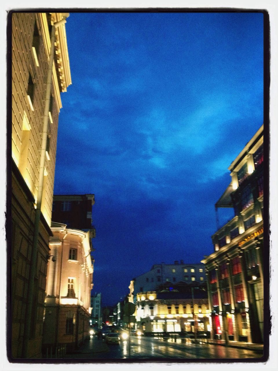 building exterior, architecture, built structure, sky, residential structure, residential building, city, transfer print, blue, auto post production filter, building, residential district, house, low angle view, cloud - sky, cloud, illuminated, outdoors, cityscape, no people