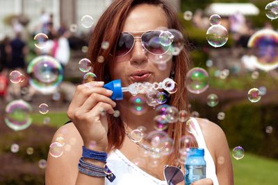 Portrait of woman holding bubbles