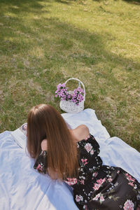 High angle view of woman relaxing on field