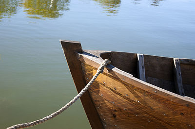 Close-up of boat moored in lake