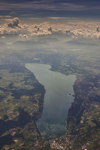 High angle view of land and sea against sky