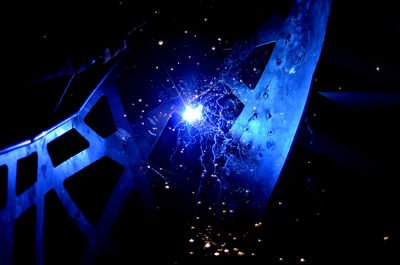 Low angle view of illuminated lights at night