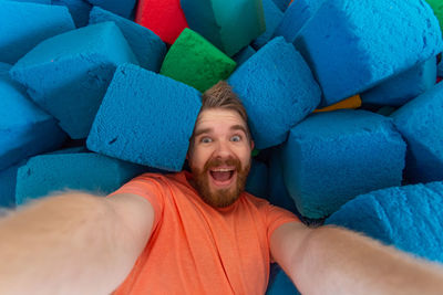 Portrait of smiling man lying down on sofa