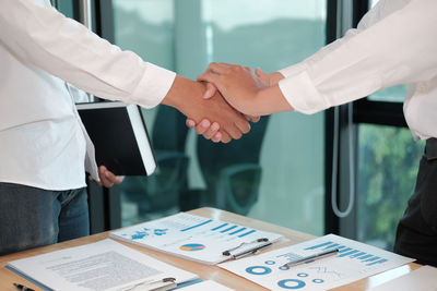 Midsection of man and woman standing on table