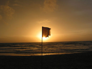 View of calm beach at sunset