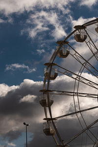 Low angle view of ferris wheel against sky