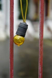 Close-up of yellow metal hanging from pole