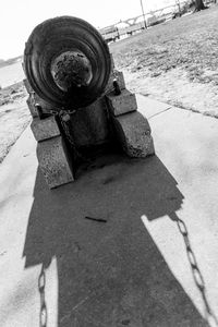 Close-up of cannon with shadow on ground