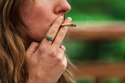 Close-up of woman smoking weed outdoors