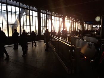 Silhouette people walking in corridor of building