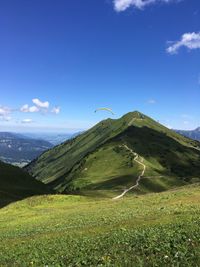 Scenic view of mountains against blue sky