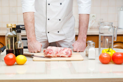 Midsection of man preparing food in kitchen