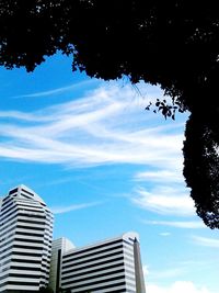 Buildings in city against blue sky