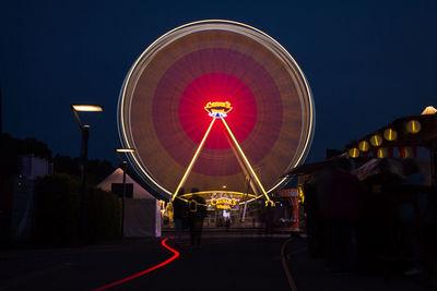 Illuminated walkway at night