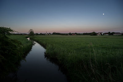 Scenic view of lake against sky at night