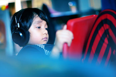 Cute boy playing while wearing headphones