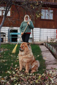 Portrait of man with dog on field