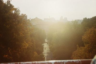 Panoramic view of town against sky during foggy weather