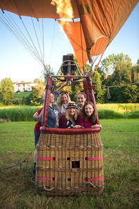 Portrait of friends standing in hot air balloon