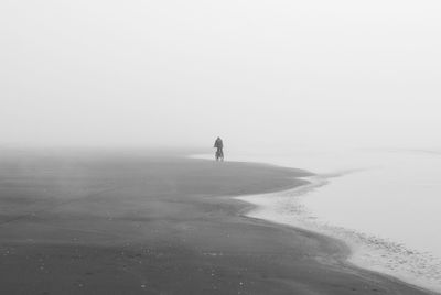 Man on beach against sky