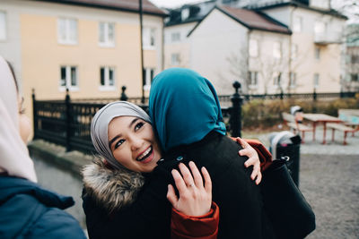 Portrait of smiling man and woman in city