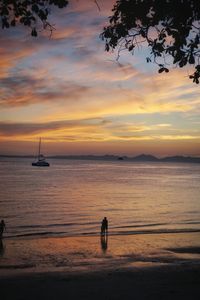 Silhouette sailboat on sea against sky during sunset