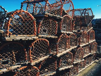 Close-up of lobster pots against sky