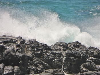 Waves splashing on rocks at shore