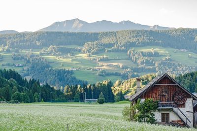Scenic view of landscape and houses against mountains