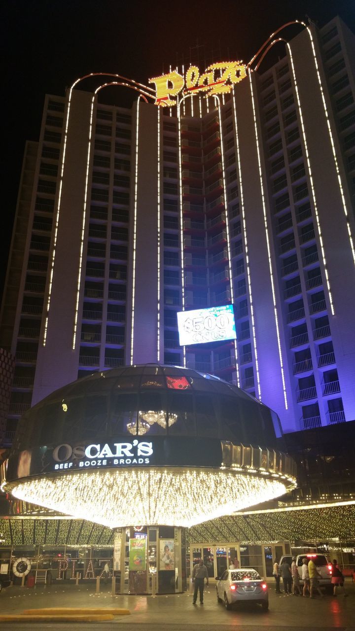 LOW ANGLE VIEW OF ILLUMINATED BUILDING AT NIGHT