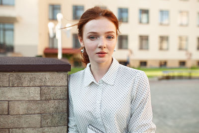 Portrait of young woman standing outdoors