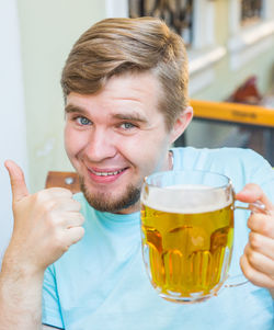 Portrait of smiling man holding drink