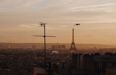 View of cityscape against cloudy sky