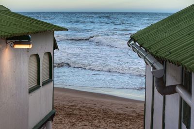 Lifeguard hut on beach against sky