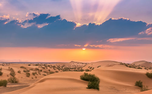Scenic view of desert against sky during sunset