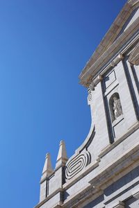 Low angle view of building against clear blue sky