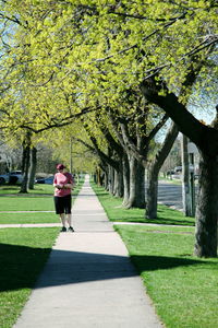 Woman walking on footpath in park
