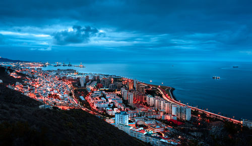 High angle view of buildings by sea against sky