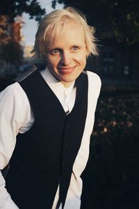 Portrait of smiling woman standing outdoors