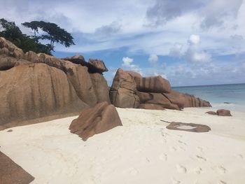 Rocks on beach against sky