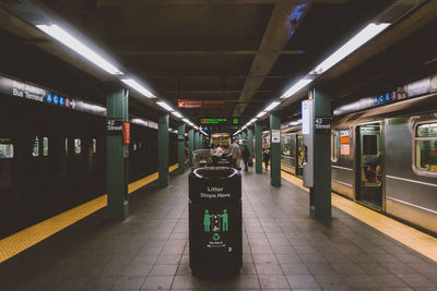 Garbage can at illuminated subway station