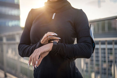 Midsection of man using mobile phone