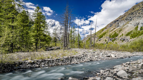 Scenic view of waterfall against sky