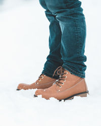 Low section of woman standing against white background