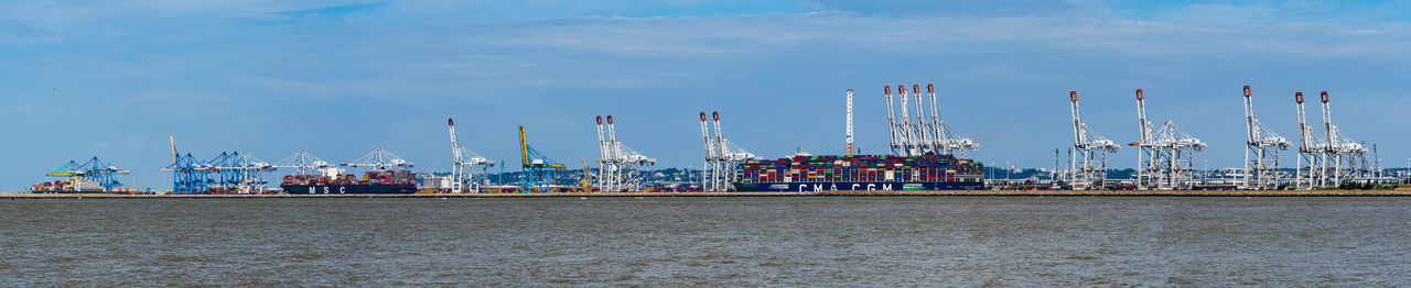 Boats in harbor against sky