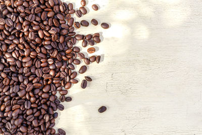 High angle view of coffee beans on wooden table