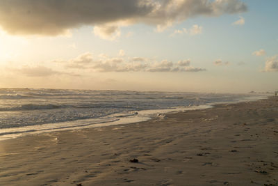 Scenic view of beach against sky during sunset