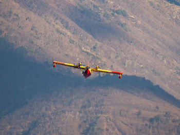 Airplane flying over mountains