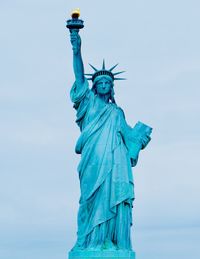 Low angle view of statue against blue sky