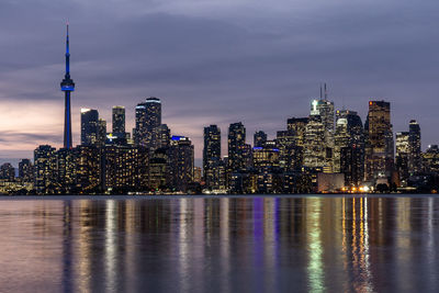 Illuminated buildings in city at waterfront